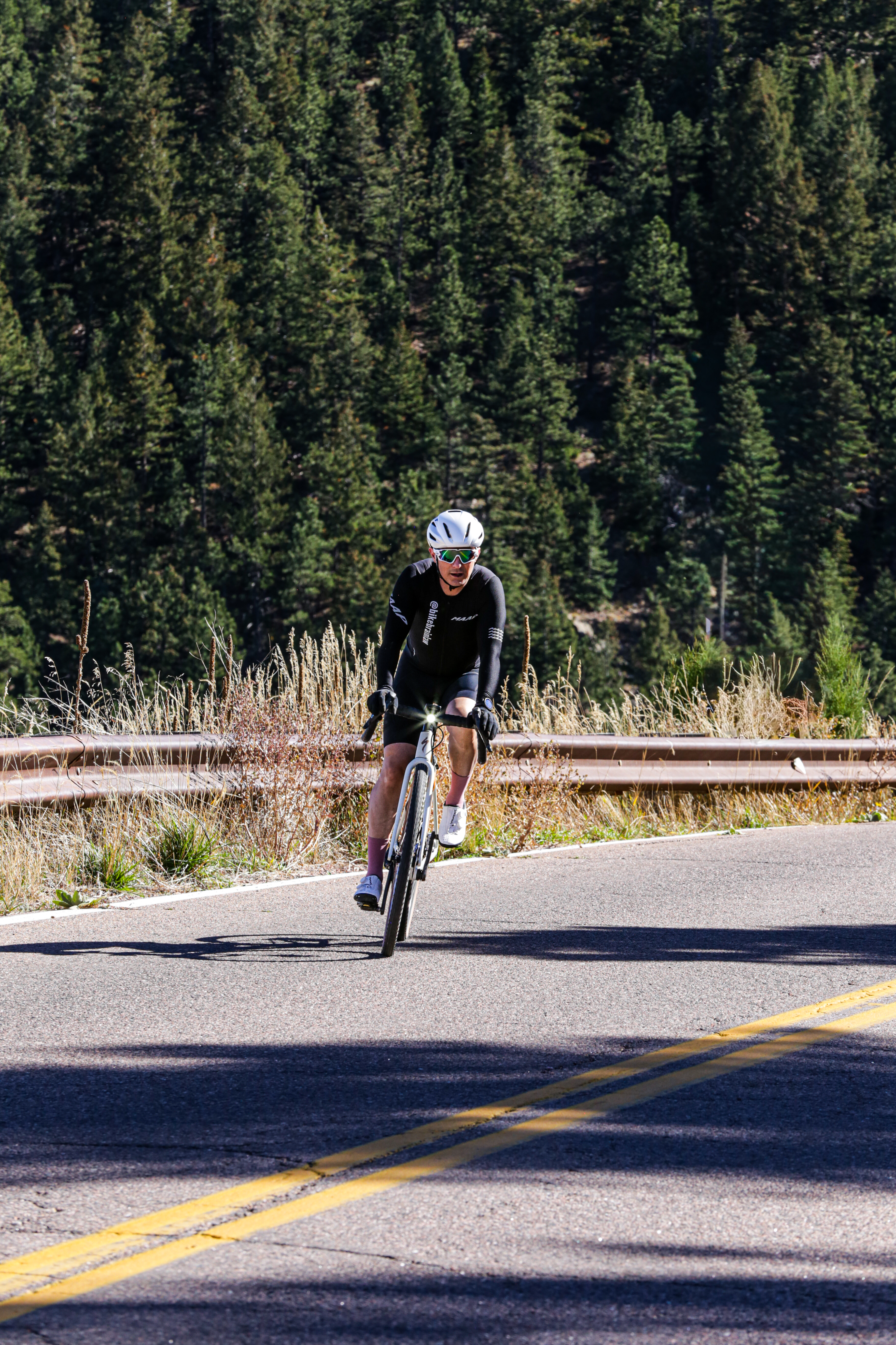 Cyclist riding with front white head lamp or light